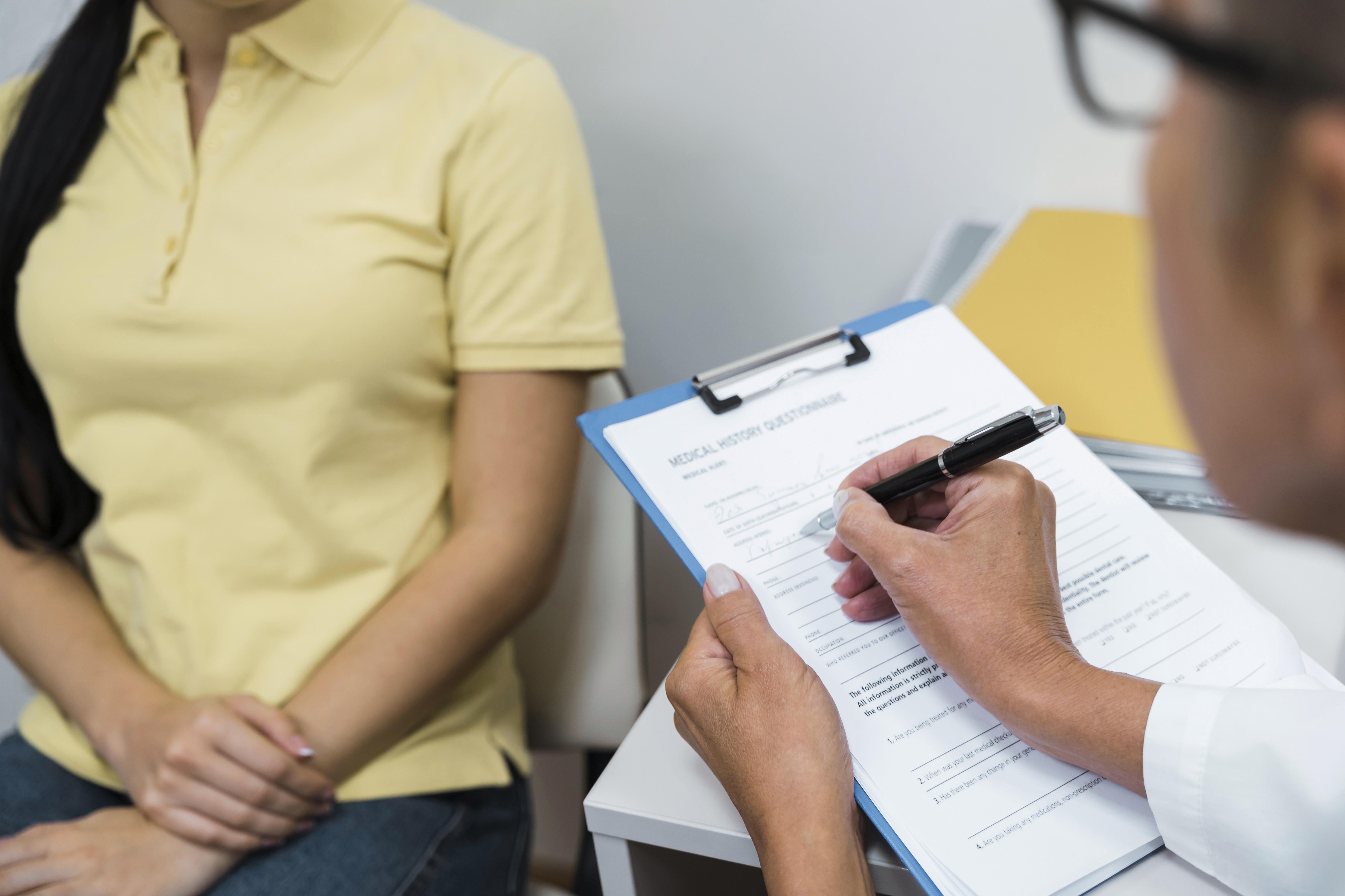high angle doctor consulting patient her office