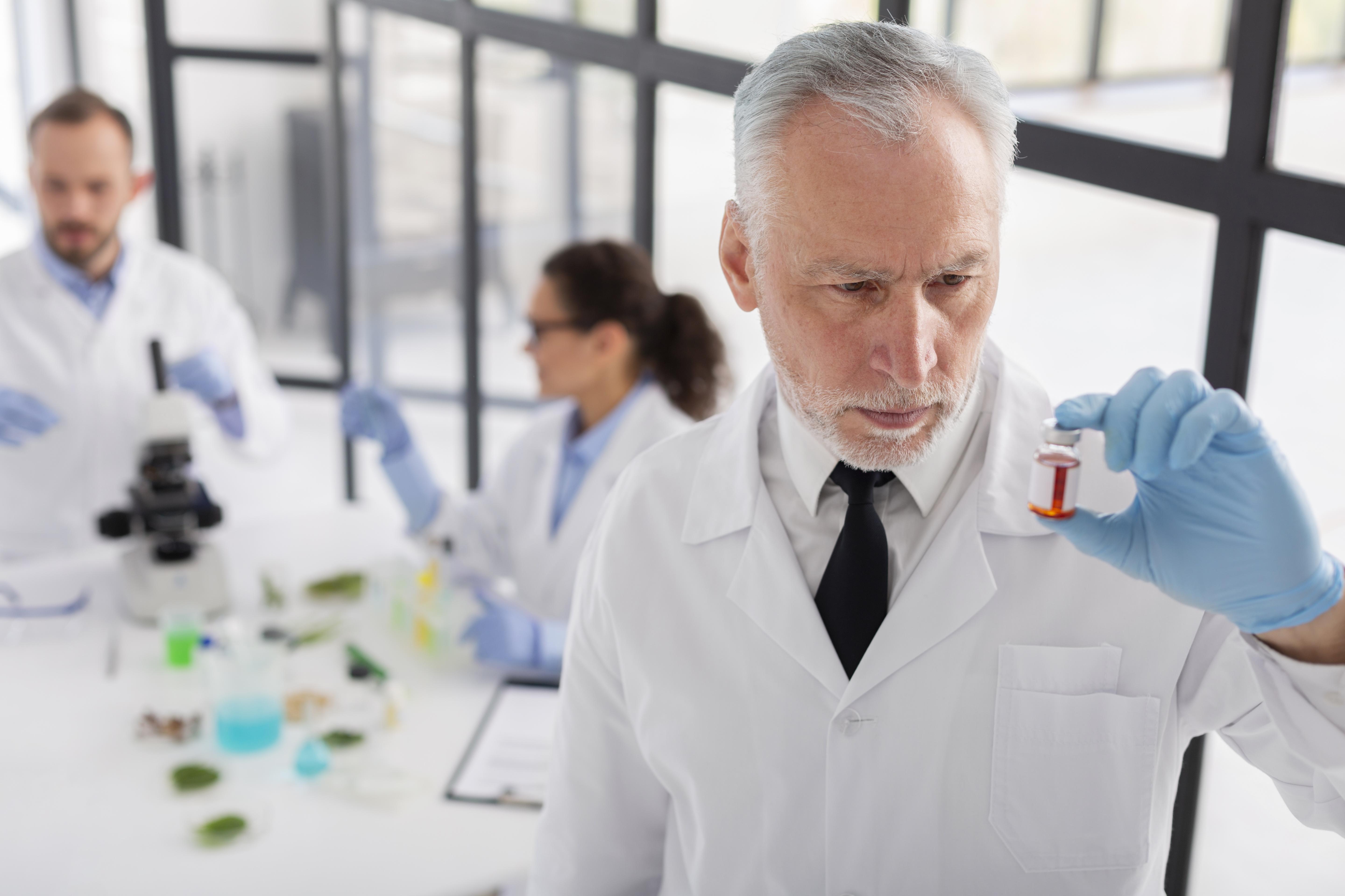 scientist holding vial medium shot